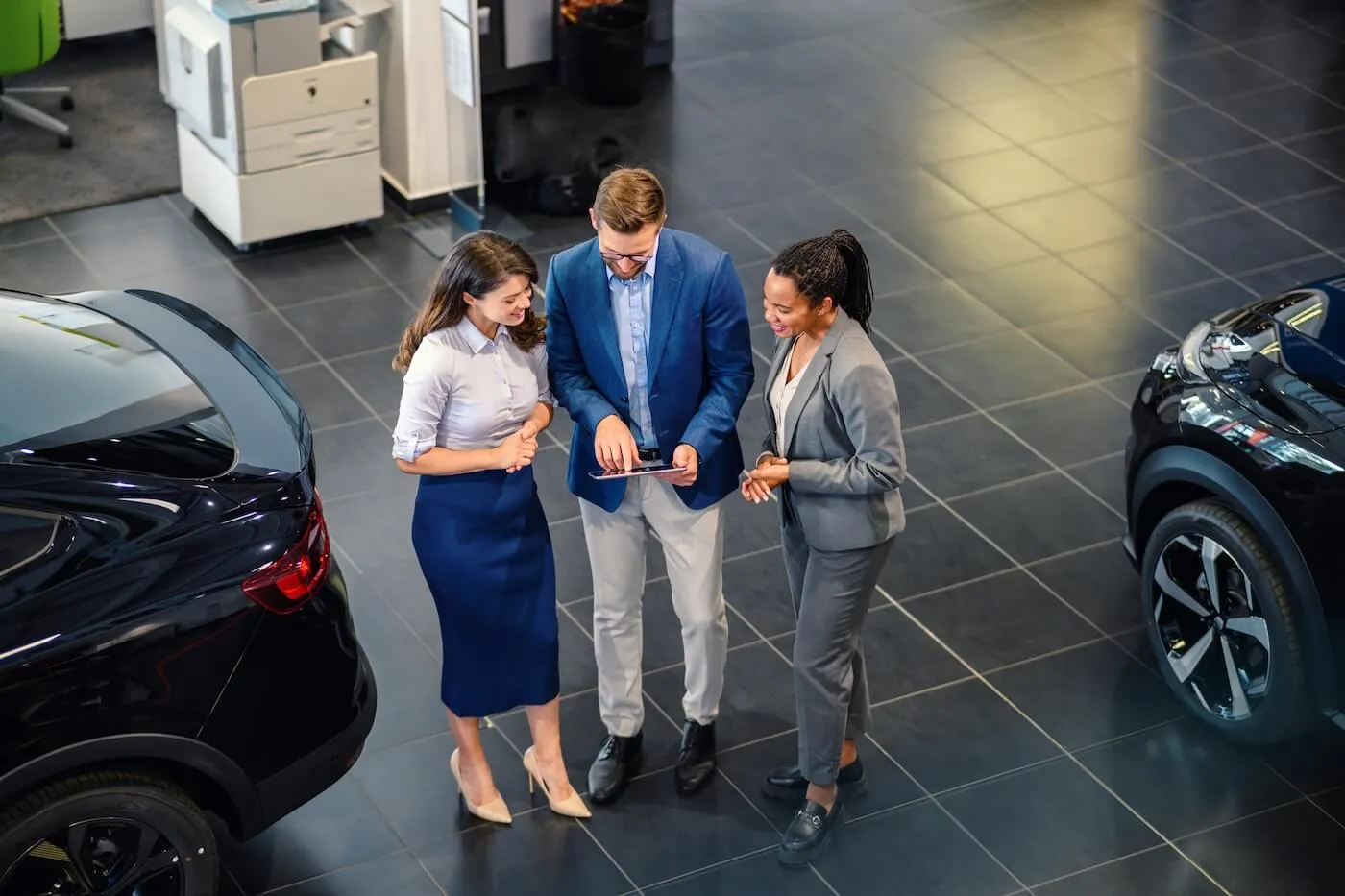 Person signing a car loan contract at a dealership